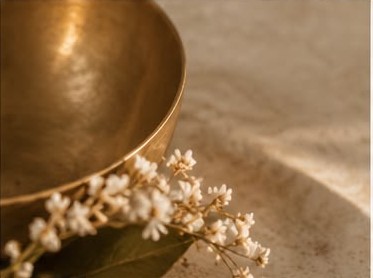A gold bowl with small white flowers